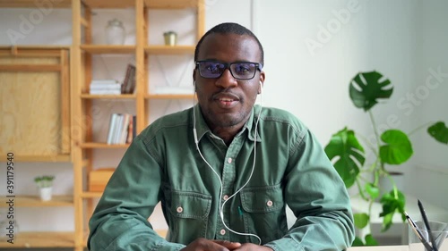 African black business man looking at camera webcam making conference video call Spbas. POV online job interview, waving for colleague, communicating with client, headshot of recruit