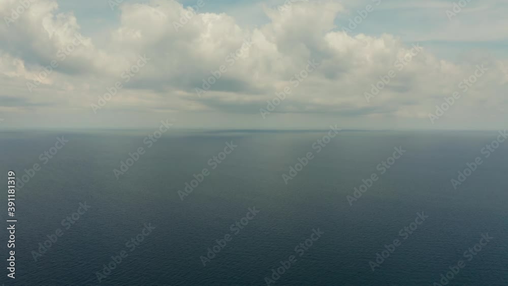 Seascape in cloudy weather, aerial view. Water cloud horizon background. Blue sea water with small waves against sky. Seascape in cloudy weather, aerial view. Water cloud horizon background. Blue sea water with small waves against sky.