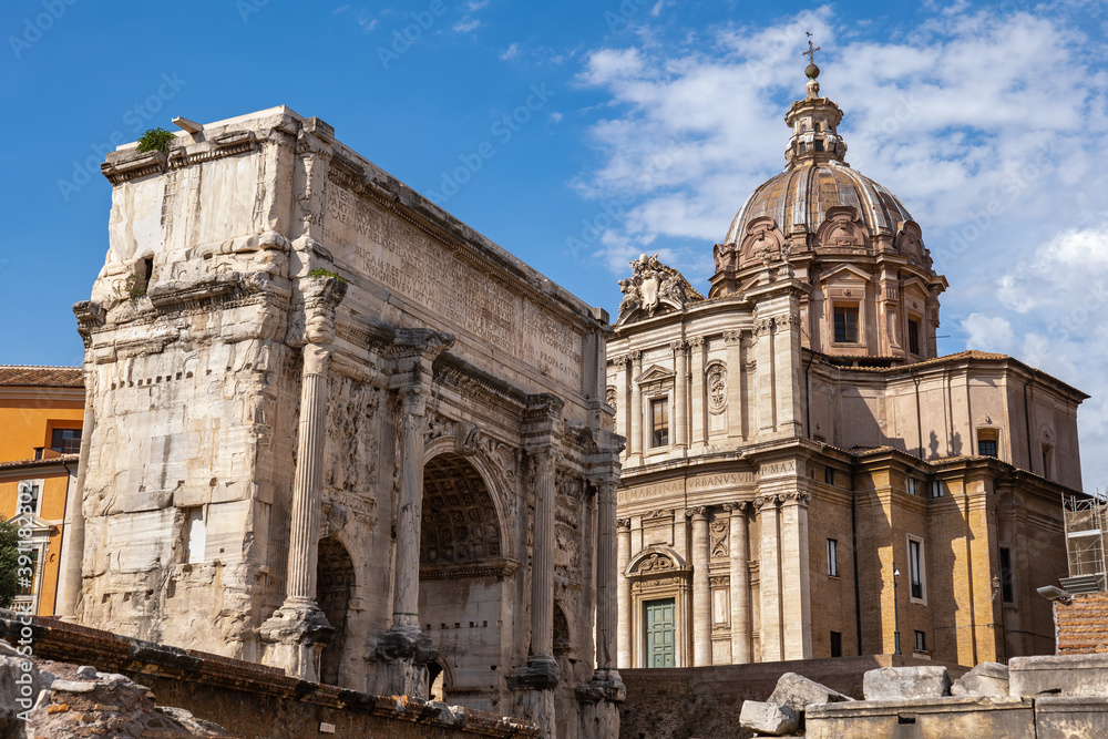 City of Rome in Italy, ancient Arch of Septimius Severus and Santi Luca e Martina church