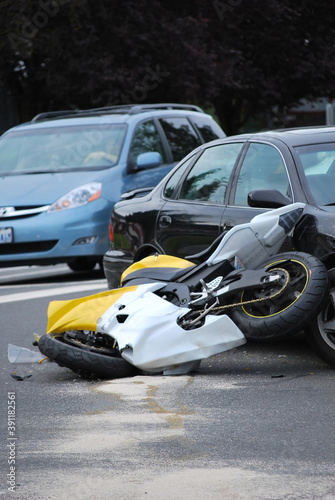 Car and motorcycle accident outdoors.