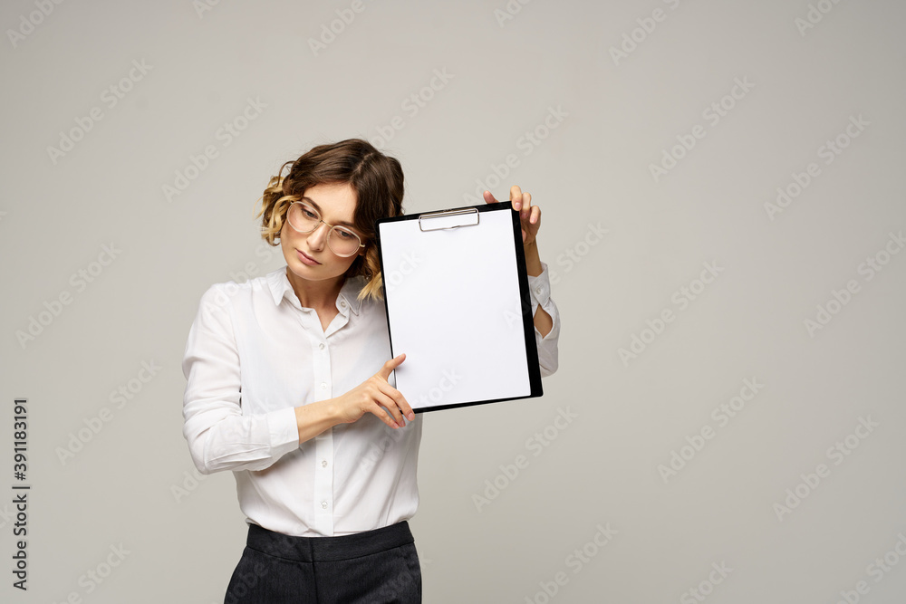 Business woman with folder of documents in hands on gray background cropped view of work