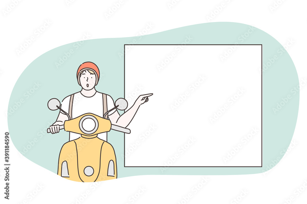 Demonstration, promotion, paying attention, advertisement concept. Young surprised frustrated motorcyclist riding and pointing with forefinger at white blank placard with copy space for text Demonstration, promotion, paying attention, advertisement concept. Young surprised frustrated motorcyclist riding and pointing with forefinger at white blank placard with copy space for text