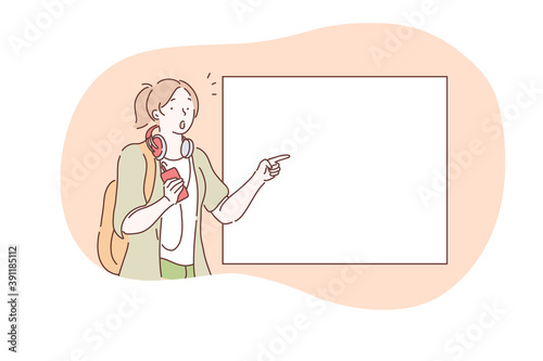 Demonstration, promotion, attention, advertisement concept. Young surprised frustrated girl cartoon character standing and pointing with finger at white blank placard with copy space for text 