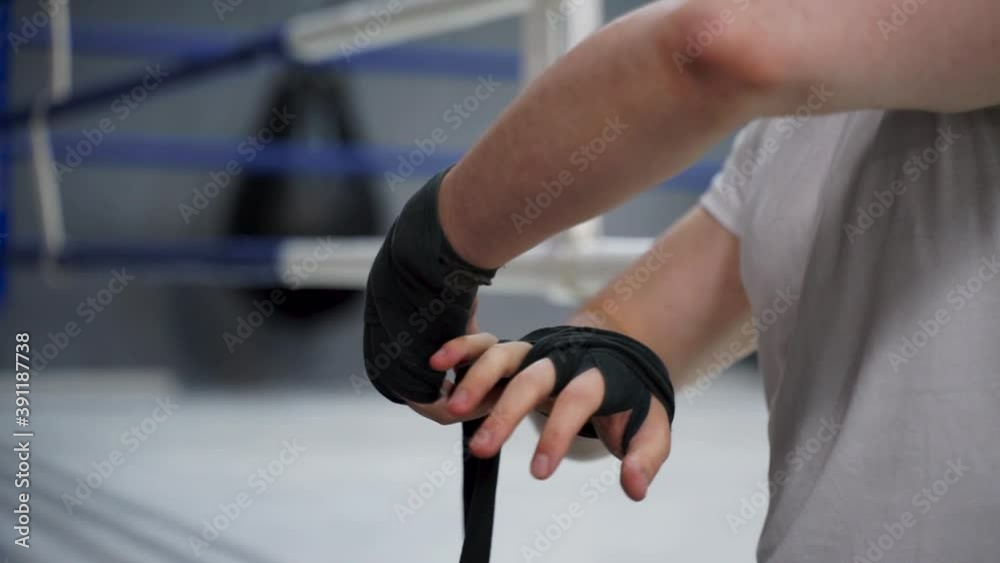 Close-up of hand wrapping with boxing bandages before training Close-up of hand wrapping with boxing bandages before training