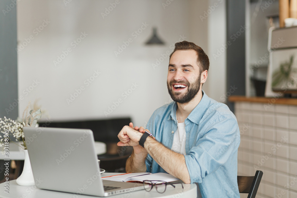 Young man sitting at desk in office and working on computer. Stock