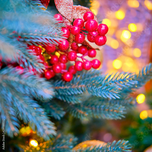 Christmas tree decorated with red glass mistletoe berries. Preparation of ornaments for the celebration of new year and Christmas, bokeh