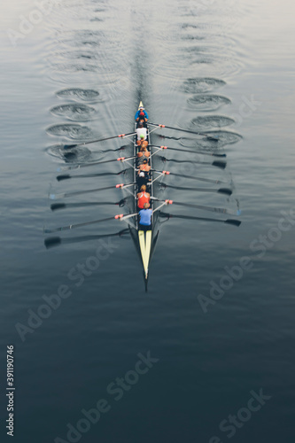 Overhead view of a crew in an eights boat rowing on a lake 