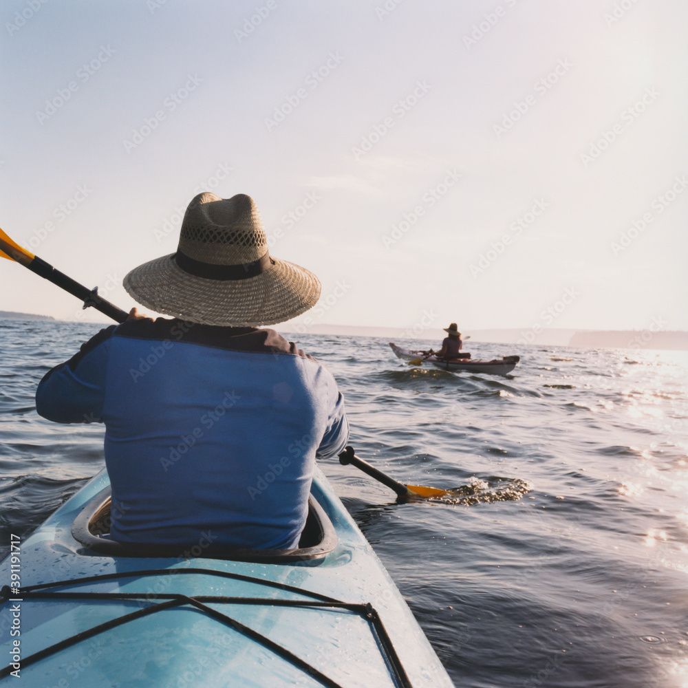 Middle aged man and woman sea kayaking. Middle aged man and woman sea kayaking.