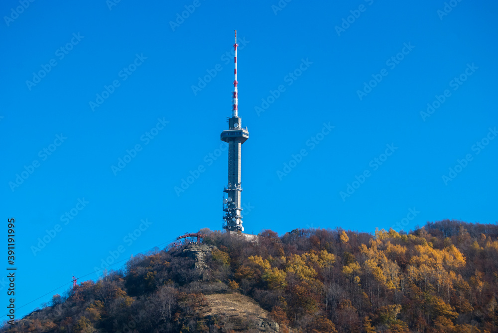 Television broadcast tower on mountain peak in clear autumn summer day Television broadcast tower on mountain peak in clear autumn summer day