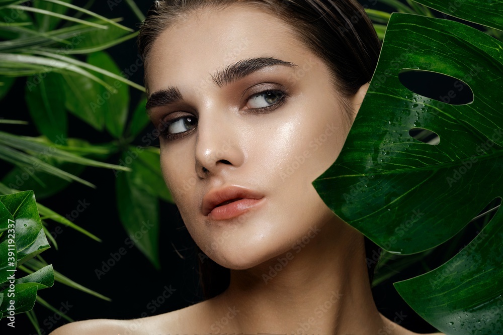 woman with bare shoulders bright makeup green leaves nature woman with bare shoulders bright makeup green leaves nature