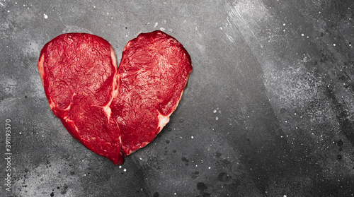 Heart shape Raw fresh meat Steak on dark background with space for text, top view