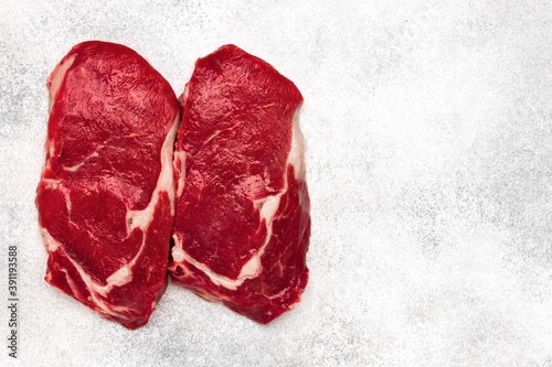 fresh raw beef steak on white background, top view,copy space