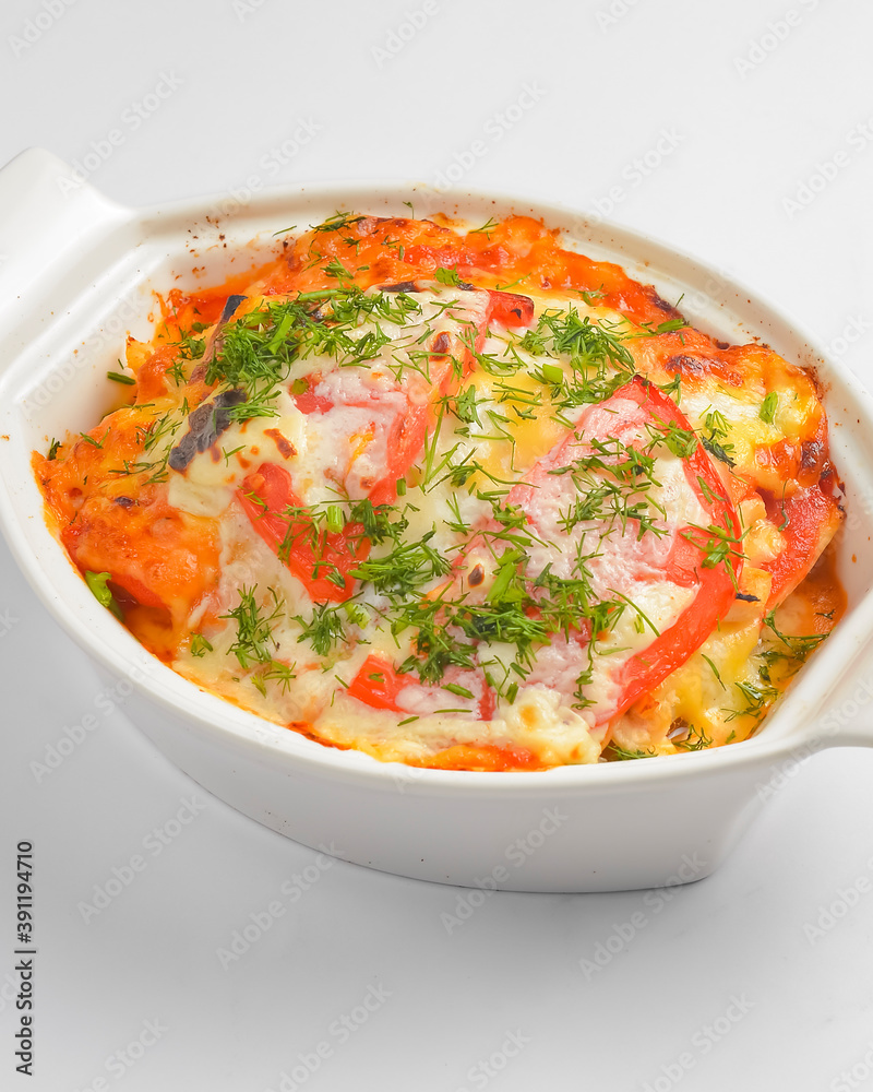Italian lasagna served in a white pot over white background. Delicioud dinner concept, Italian cuisine. Italian lasagna served in a white pot over white background. Delicioud dinner concept, Italian cuisine.