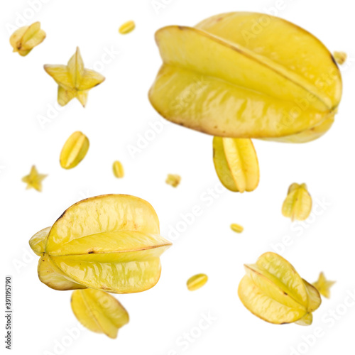 Many carambole star fruits free falling on white background. Selective focus - shallow depth of field.