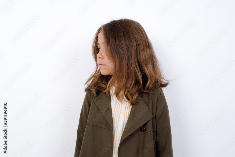Side view of young happy smiling Beautiful little girl standing against white background. Side view of young happy smiling Beautiful little girl standing against white background.