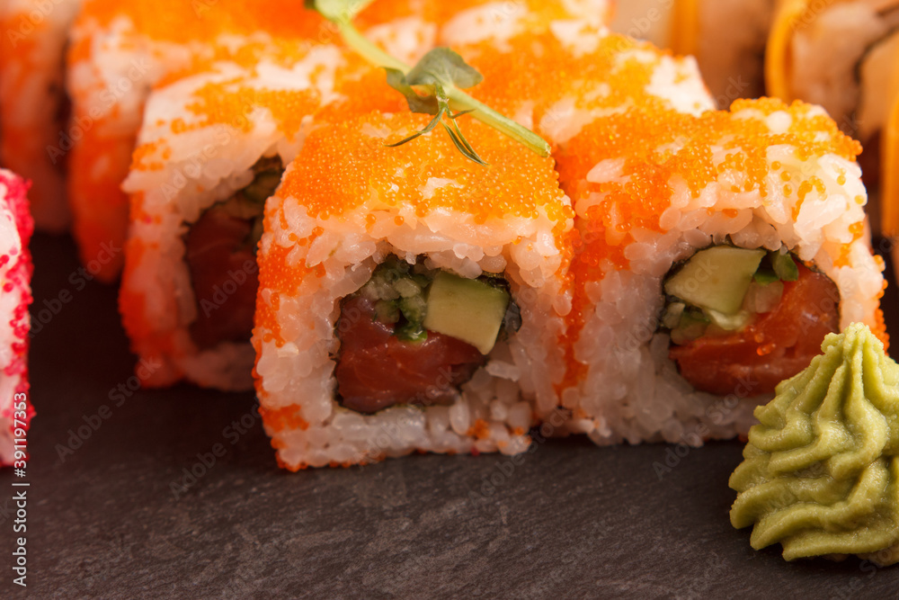 Japanese food: Set of salmon sushi and rolls with salmon and eel Japanese food: Set of salmon sushi and rolls with salmon and eel