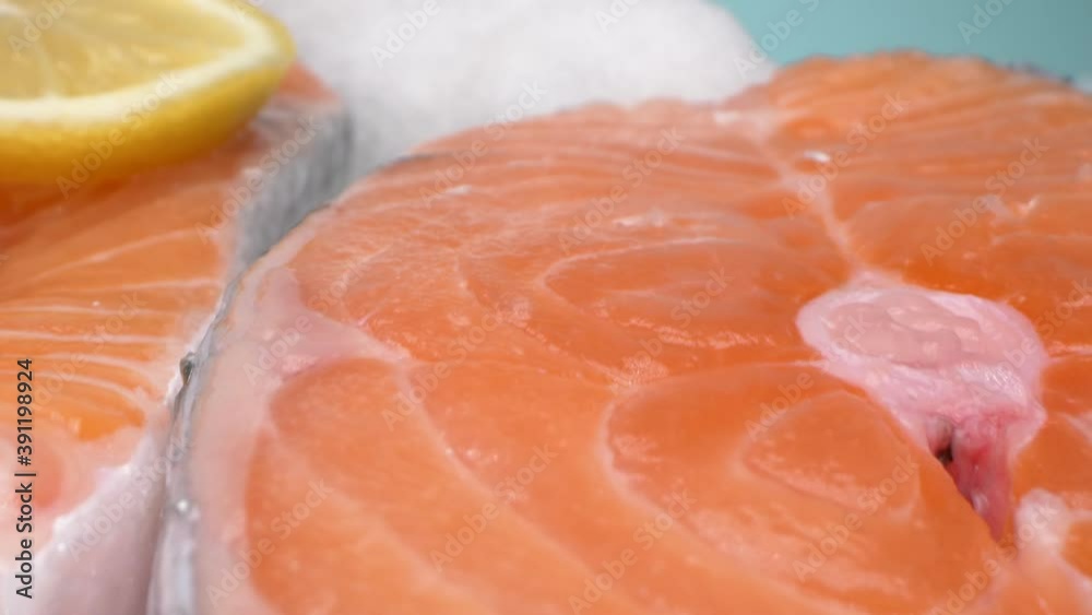 extreme close-up, detailed. salmon steak on ice. blue background. extreme close-up, detailed. salmon steak on ice. blue background.
