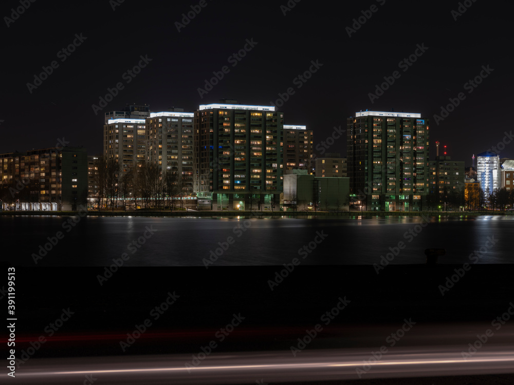Fototapeta premium A modern residential district casting reflections to the waterfront.