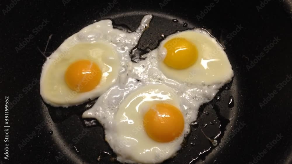 Sunny side eggs frying in a frying pan Sunny side eggs frying in a frying pan