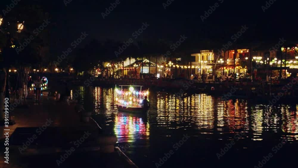 Boat rowing with colorful lanterns and lights at night in Thu Bồn River at Hoi An, Vietnam Boat rowing with colorful lanterns and lights at night in Thu Bồn River at Hoi An, Vietnam