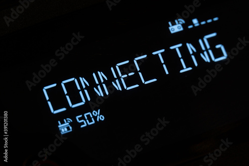 A text message that appears with a deep glow: connect. Luminous text on the computer screen, monitor, or LCD display. With charging percentages