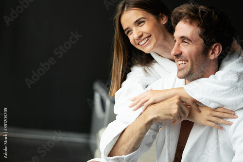 Couple in bathrobes enjoying honeymoon in spa resort