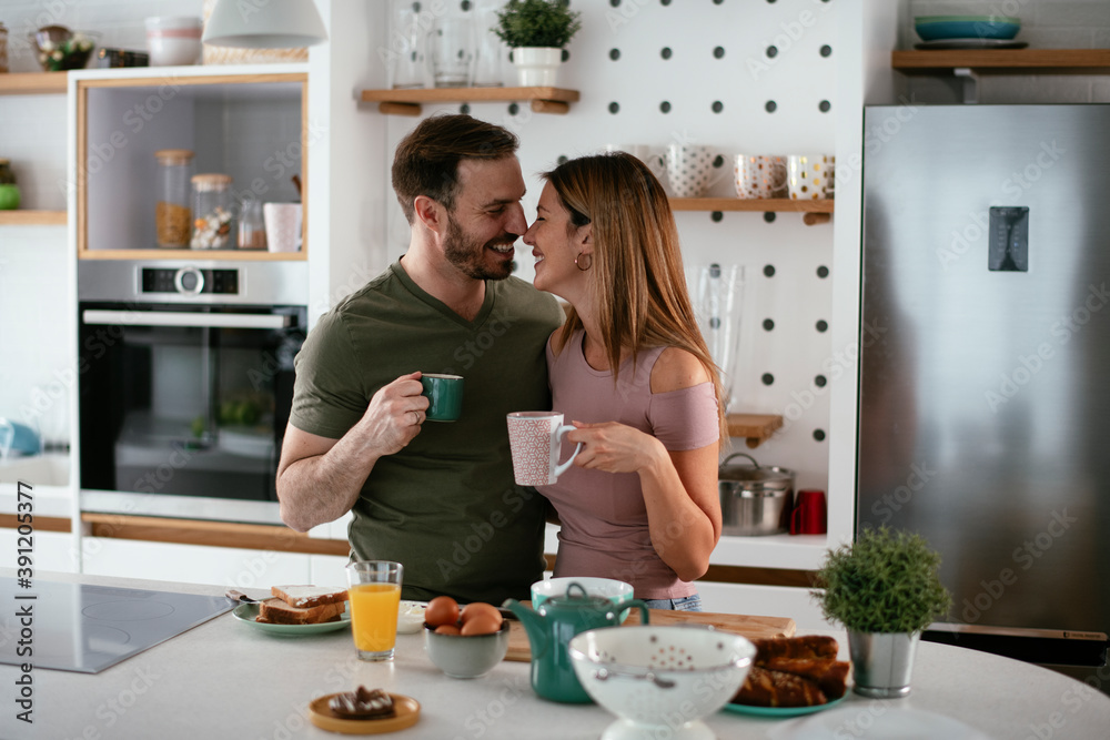 Young couple making sandwich at home. Loving couple enjoying in the kitchen. Young couple making sandwich at home. Loving couple enjoying in the kitchen.