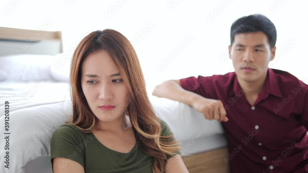 Asian couple have a fight in bedroom. Asian couple having difficulties in relationship. Wife always sulking. He has problem with erection too. Domestic violence concept. Asian couple have a fight in bedroom. Asian couple having difficulties in relationship. Wife always sulking. He has problem with erection too. Domestic violence concept.
