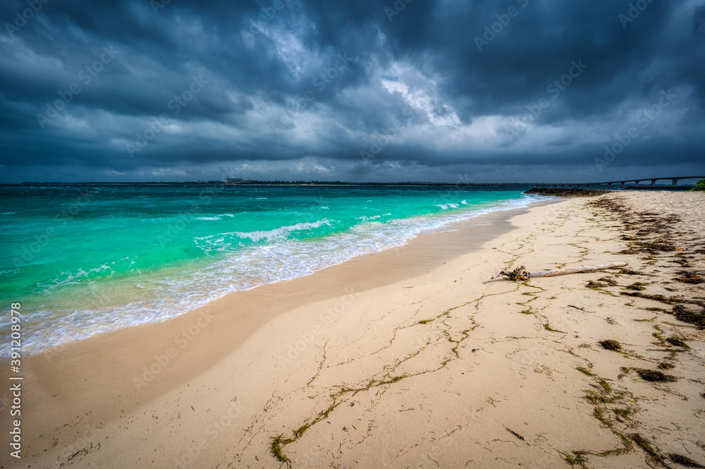 Fototapeta premium Storm clouds contrast with the turquoise waters and white sandy beaches of Kurima Island, Miyakojima, Okinawa, Japan