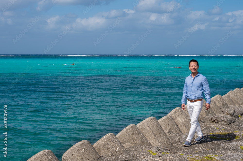 Aman walks on a beach in Irabu Island, Miyakojima, Okinawa, Japan