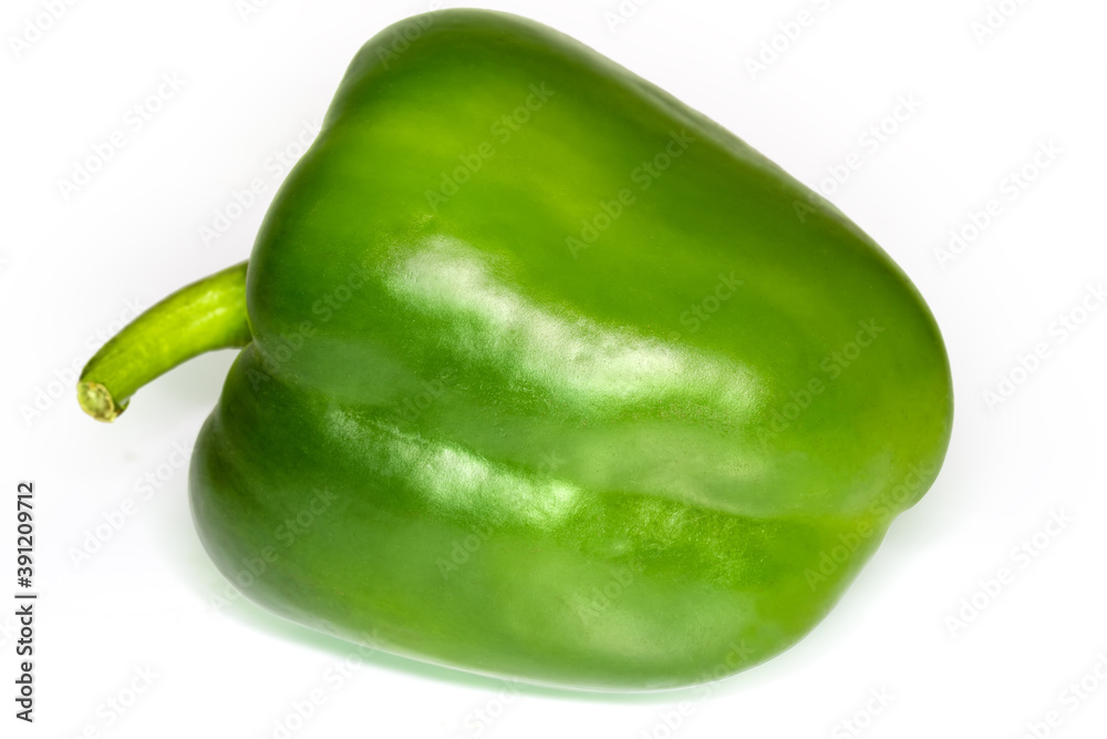 Whole green bell pepper on a white background close-up Whole green bell pepper on a white background close-up
