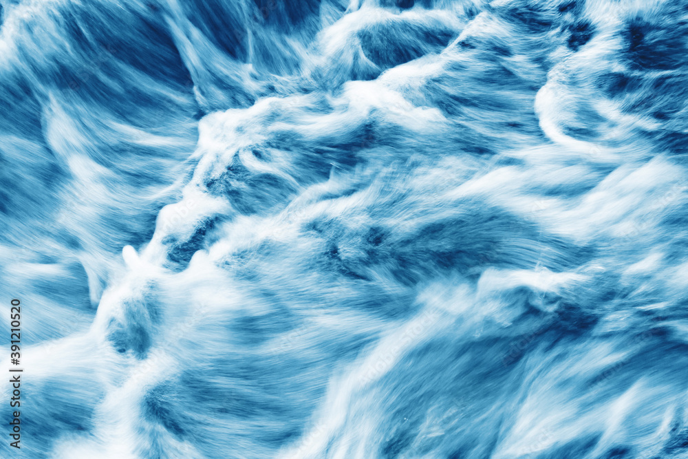 Obraz premium Water motion background. Abstract foam smudges texture. Turbulent river flow. Waterfall closeup.