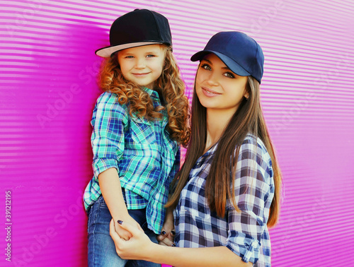 Photography Portrait of young mother with child little girl wearing a checkered shirts and b