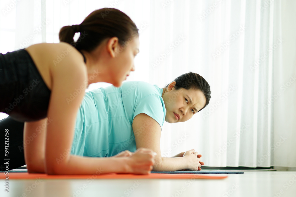 Two woman practicing yoga together Two woman practicing yoga together