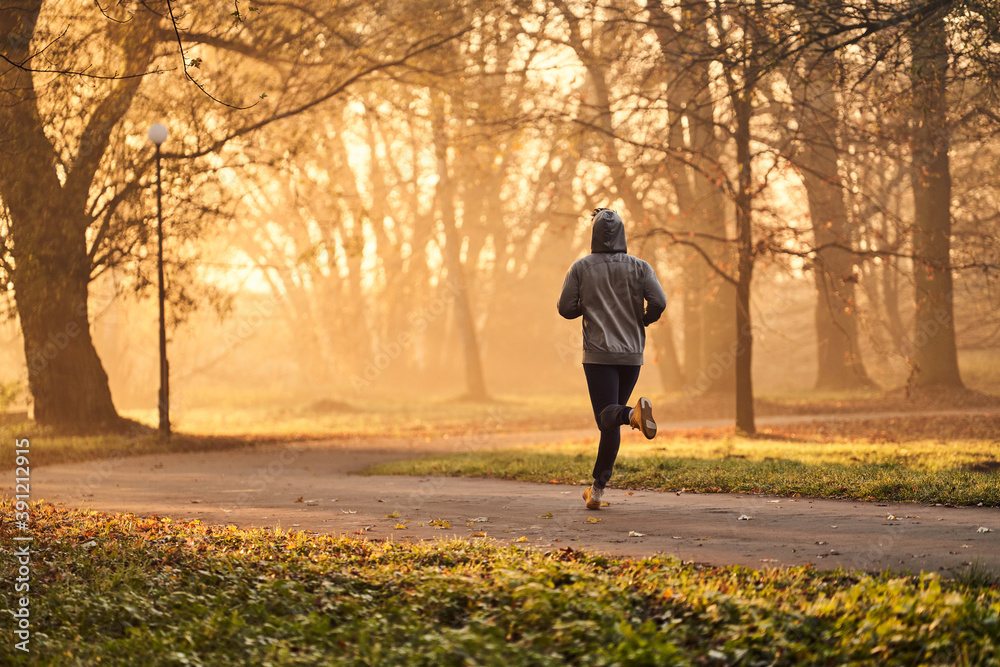 Man running in park at autumn, fall during early morning. Healthy lifestyle concept. Man running in park at autumn, fall during early morning. Healthy lifestyle concept.