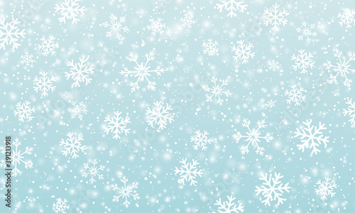 Snow background. Winter snowfall. White snowflakes on blue sky. Christmas background. Falling snow.