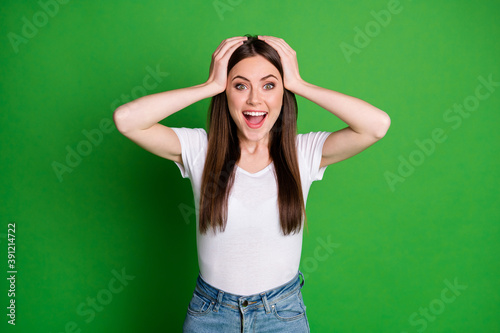 Photo of surprised student wear casual outfit hands head open mouth isolated green color background © deagreez