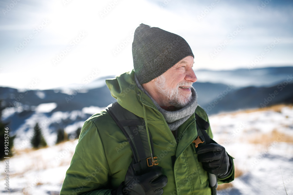 Portrait of senior man standing in snow-covered winter nature. Portrait of senior man standing in snow-covered winter nature.