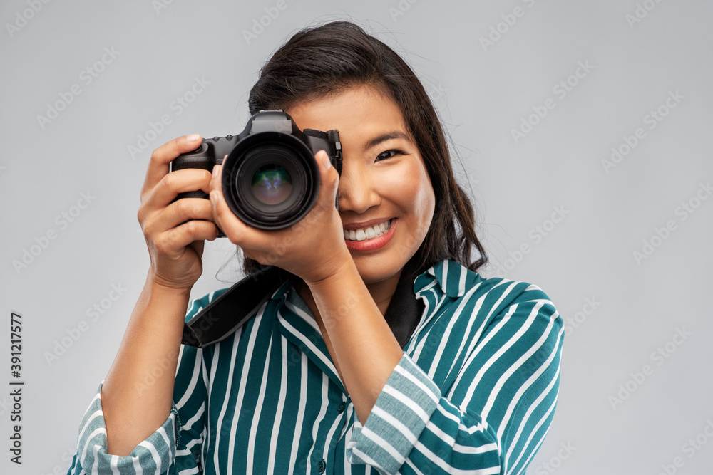 photography, profession and people and concept - happy smiling asian female photographer with digital camera photography, profession and people and concept - happy smiling asian female photographer with digital camera
