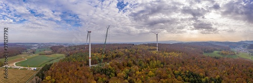Drone image of a wind turbine under construction in a forest area in Germany