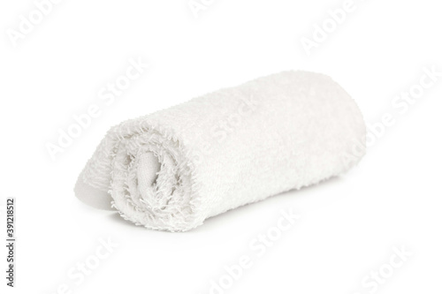 one white new towel rolled up on a white background