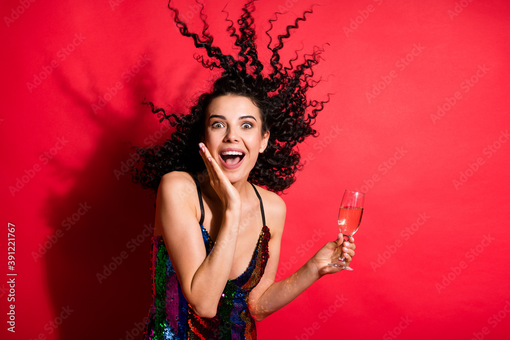 Naklejka premium Photo of young charming girl hold wineglass open mouth palm cheek wear glossy dress isolated red color background