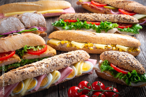 Assorted sandwiches on wooden background