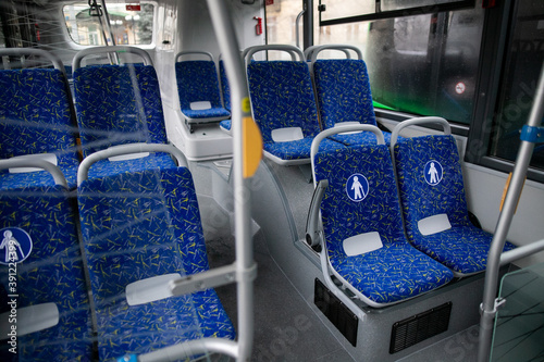 Empty bus interior. Blue seats without passengers. Public transport. Transportation of passengers by public transport. Ergonomic interior of the bus. Travel to other cities.