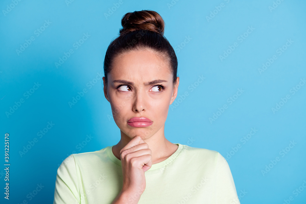 Photo of frustrated girl look empty space touch finger chin think thoughts isolated over blue color background Photo of frustrated girl look empty space touch finger chin think thoughts isolated over blue color background
