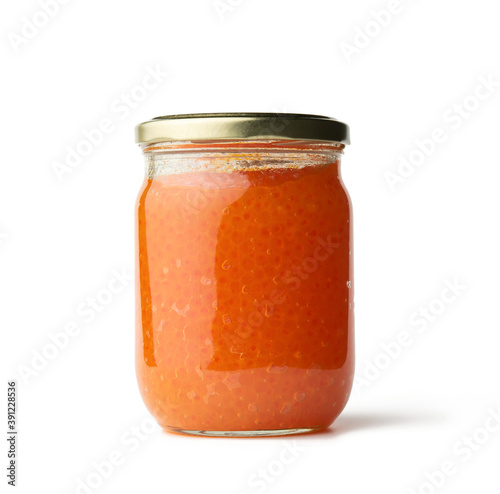 glass jar with fresh pink salmon caviar isolated on white background