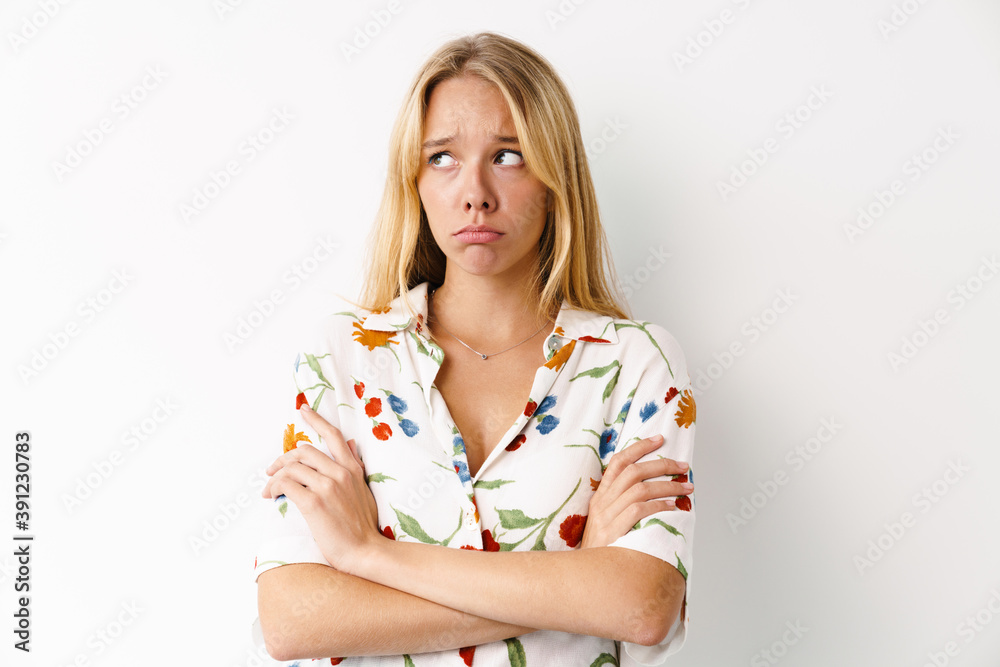 Unhappy beautiful girl posing with arms crossed at camera Unhappy beautiful girl posing with arms crossed at camera