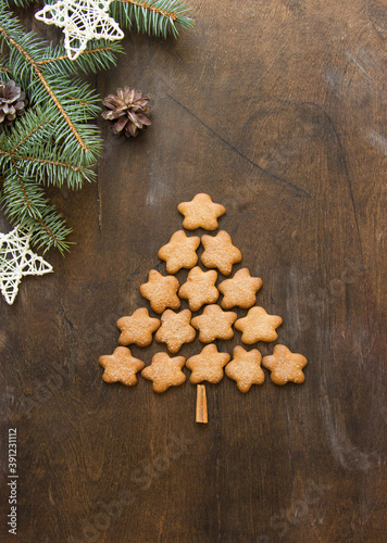 Christmas tree made of gingerbreads on a wooden background. Christmas, new year, festive, kids, food concept. free space for text