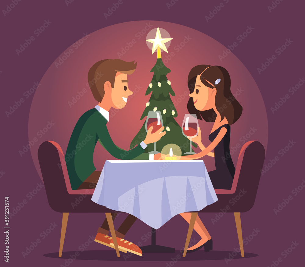 Sweet happy couple having romantic dinner with glasses of red wine on date. Drink wine. Beautiful romantic young couple. Christmas evening celebration.Eating together and having conversation.