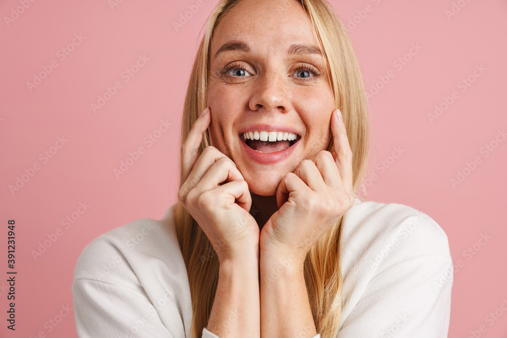 Cheerful beautiful girl smiling and pointing fingers at her cheeks Cheerful beautiful girl smiling and pointing fingers at her cheeks